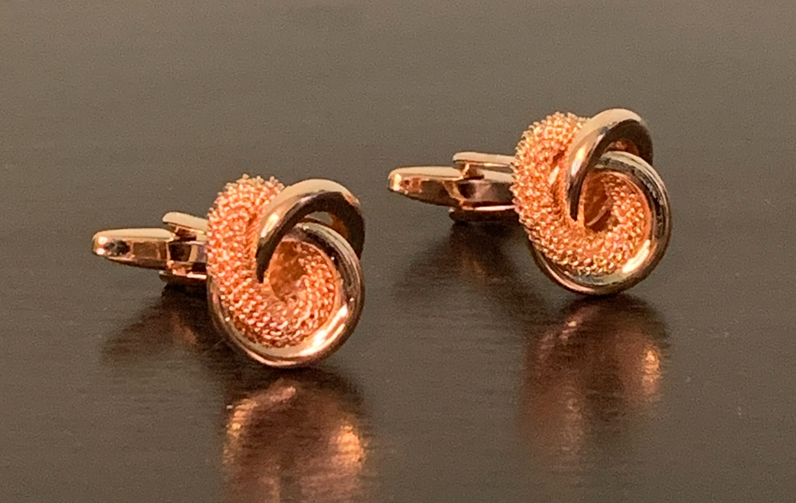 Elegant rose gold cufflinks featuring a unique knot design, symbolizing integrity and commitment.