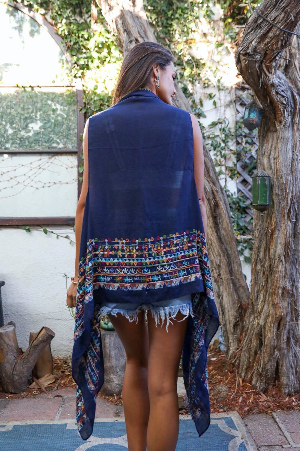 A stylish Geometric Embroidered Sleeveless Kimono featuring intricate geometric patterns, perfect for warm weather and versatile outfits.