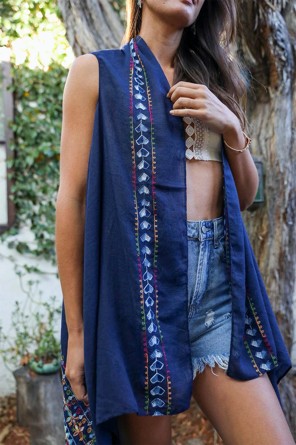 A stylish Geometric Embroidered Sleeveless Kimono featuring intricate geometric patterns, perfect for warm weather and versatile outfits.