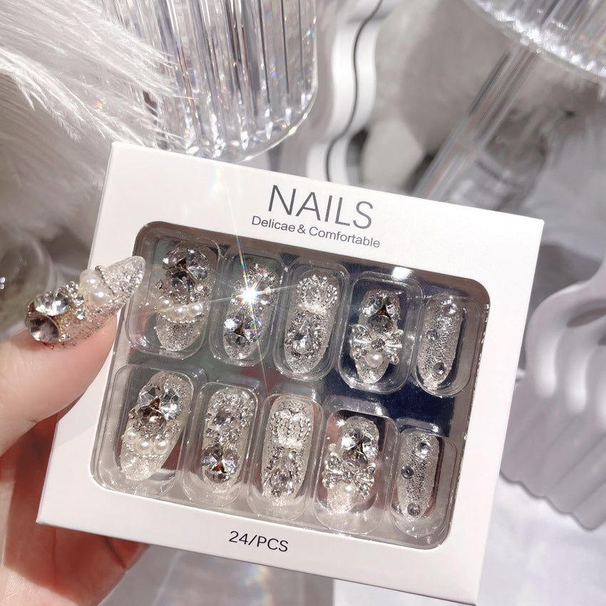 A beautifully arranged box of Glamour Galore 24-piece sparkling gem fake nails, showcasing various designs and included nail care tools.