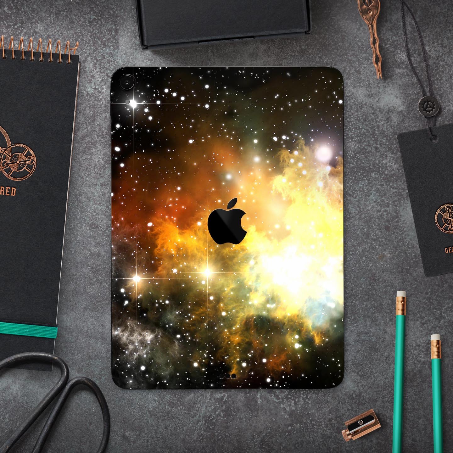 Glowing Gold & Black Nebula skin decal for Apple iPad, showcasing vibrant colors and a sleek design.