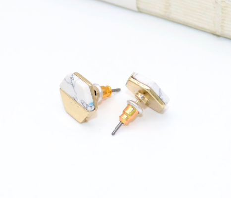 Gold and white marble stud earrings in hexagon shape, showcasing a modern and elegant design, perfect for sensitive ears.