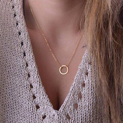 A delicate gold small circle necklace featuring a minimalist design, perfect for layering and everyday wear.