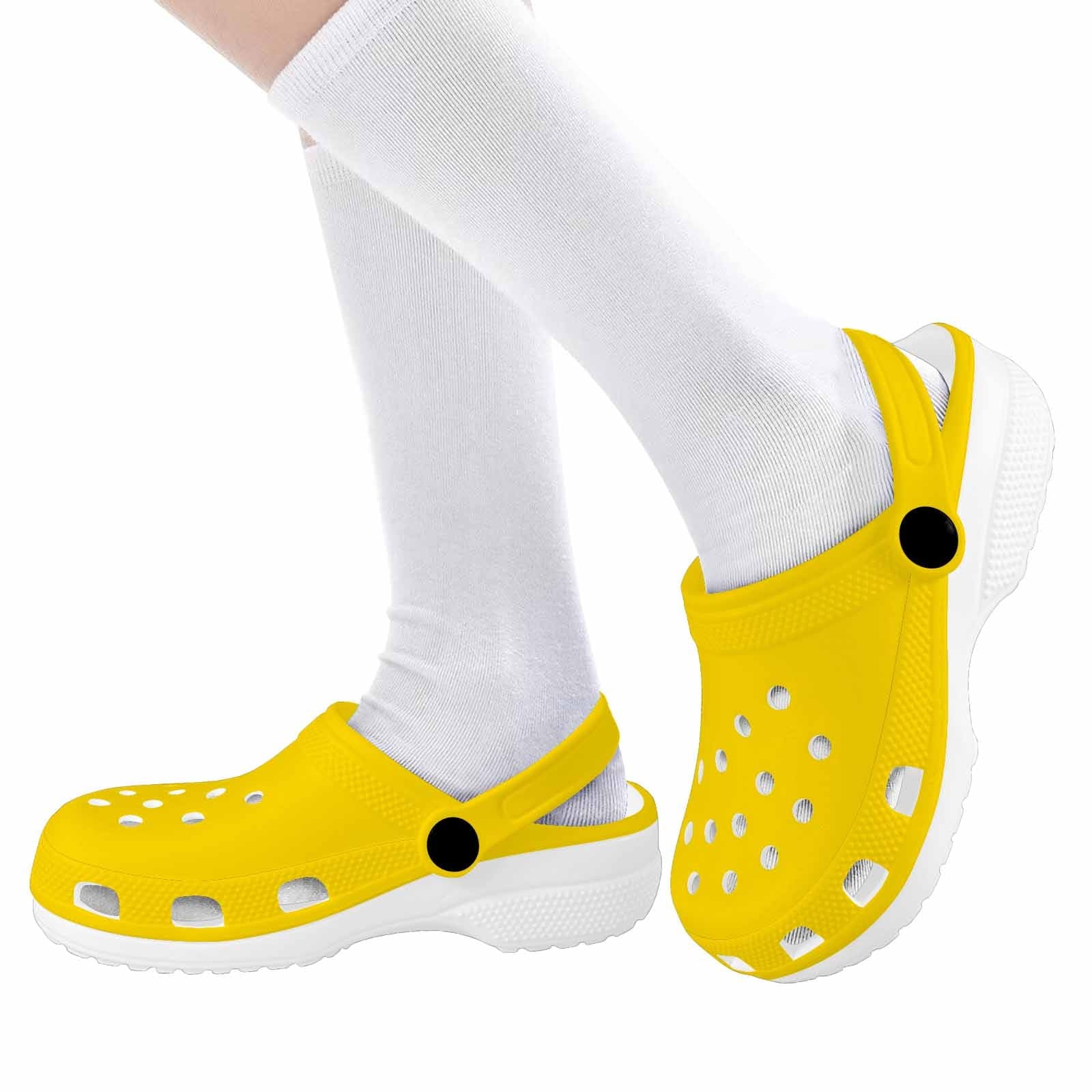 A pair of stylish gold yellow clogs designed for youth, featuring a slip-on design and cushioned sole for comfort.