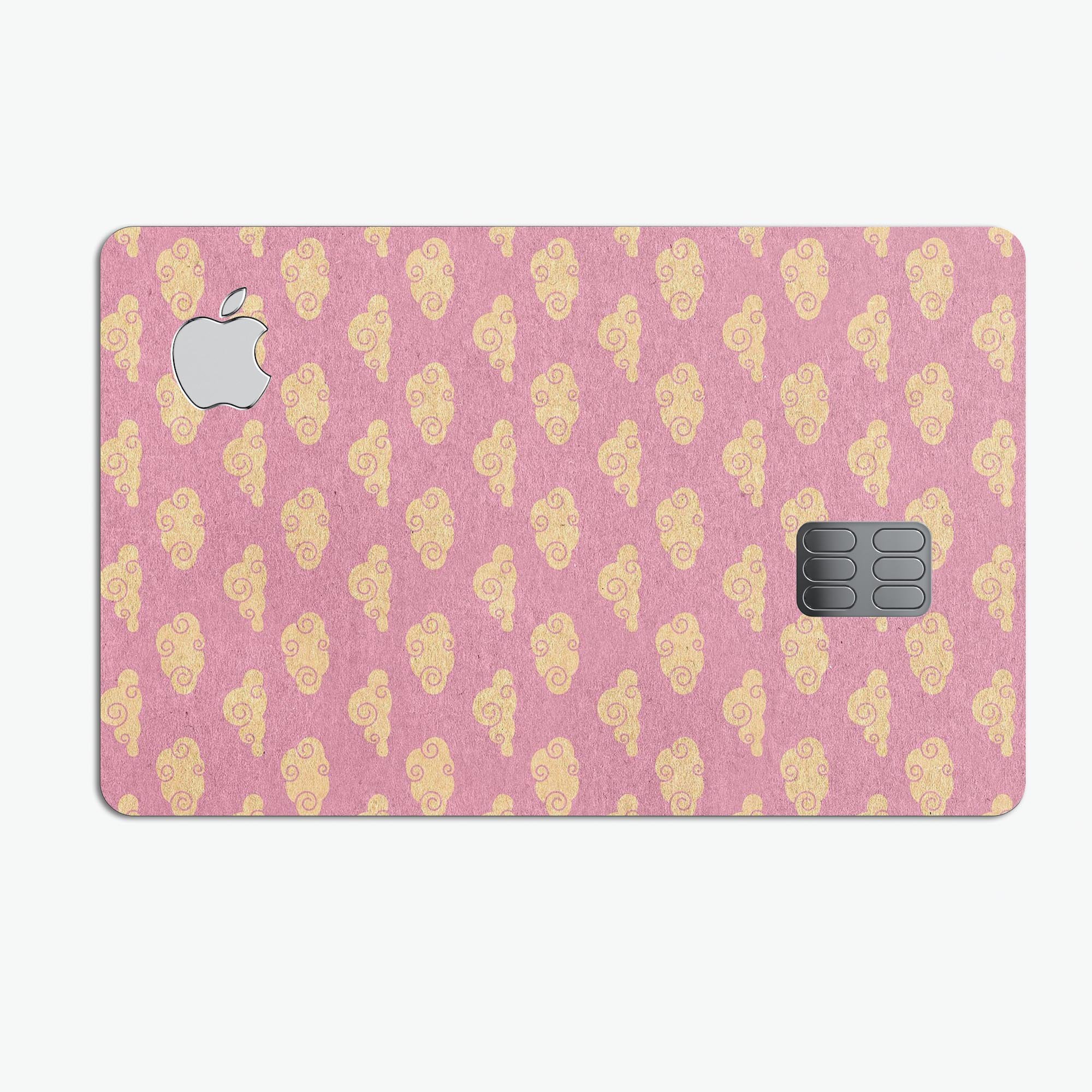 Golden Cartoon Clouds design on a pink background, showcasing a premium protective decal skin for Apple Card.