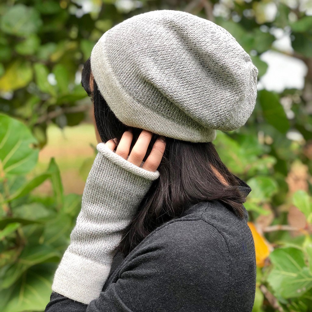 Gray interwoven alpaca fingerless gloves showcasing a textured design, perfect for style and warmth.