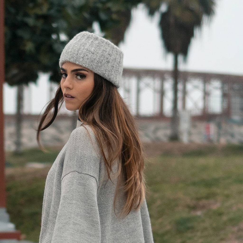 Gray ribbed alpaca ear warmer headband, showcasing its cozy texture and handmade quality.