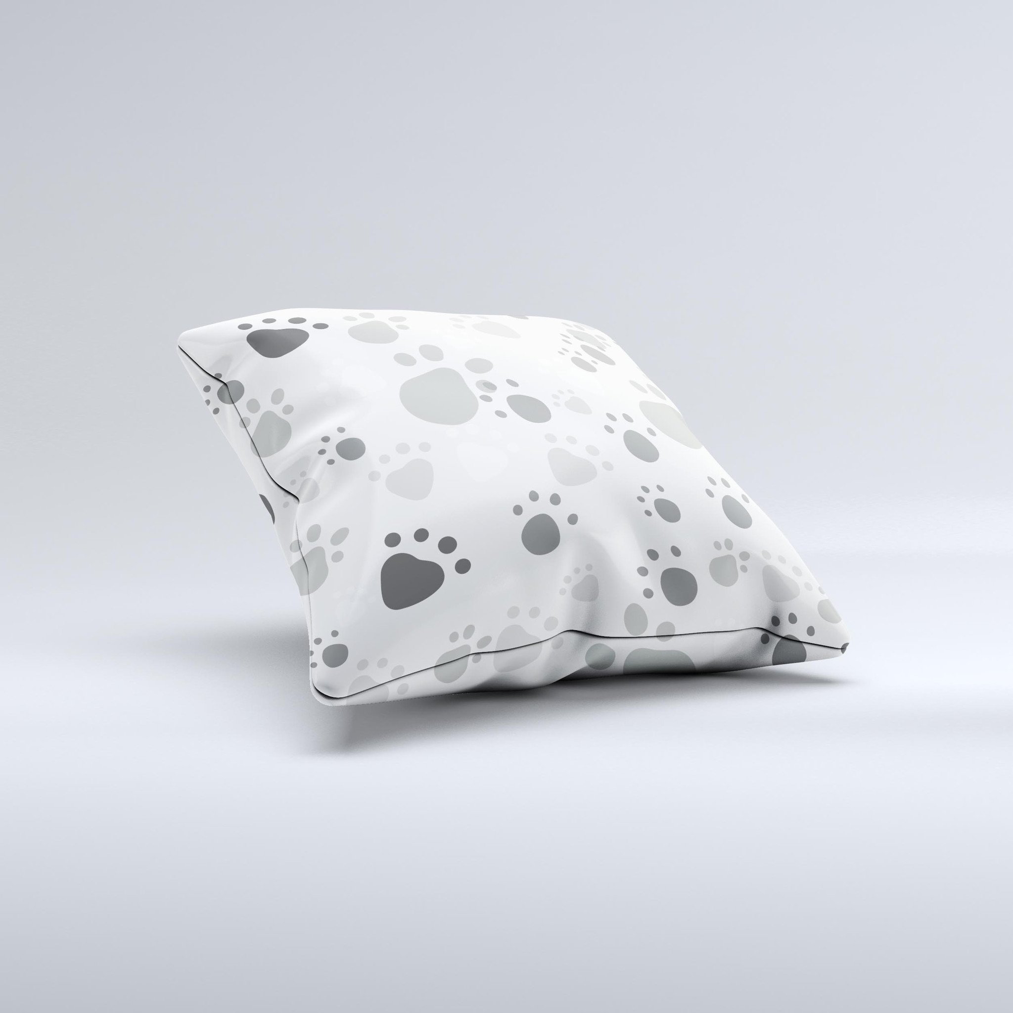 Gray and white decorative throw pillow featuring large paw prints, handcrafted in Virginia with high-quality materials.