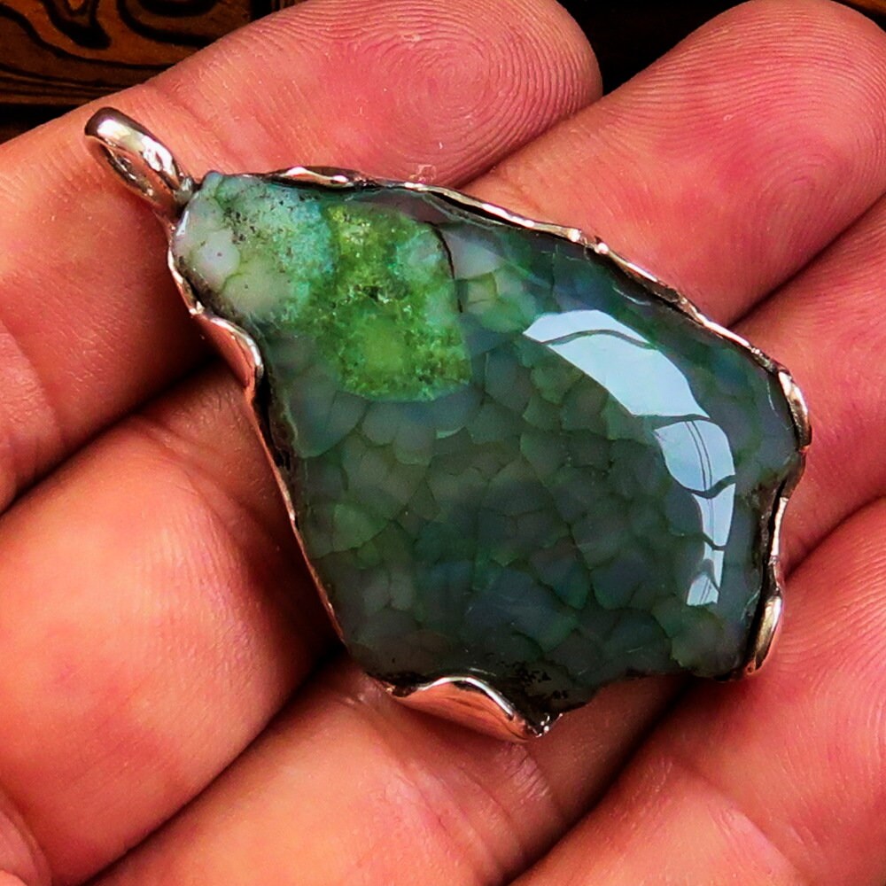 A beautiful Green Agate Amulet pendant set in Sterling Silver, showcasing a vibrant green druzy stone with intricate natural patterns.