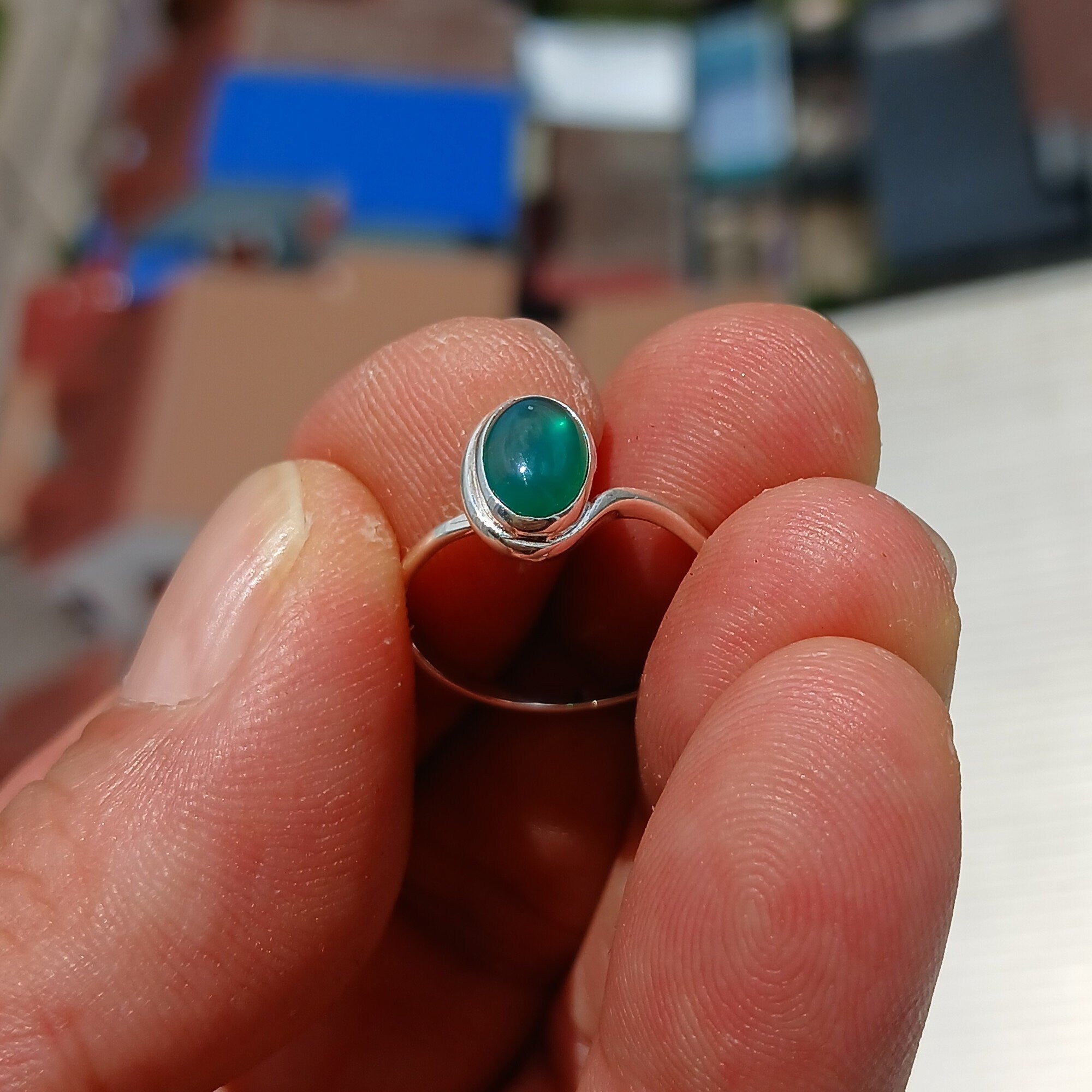 A minimalist Green Agate Ring featuring a handmade sterling silver band and an oval green Agate cabochon, elegantly polished.