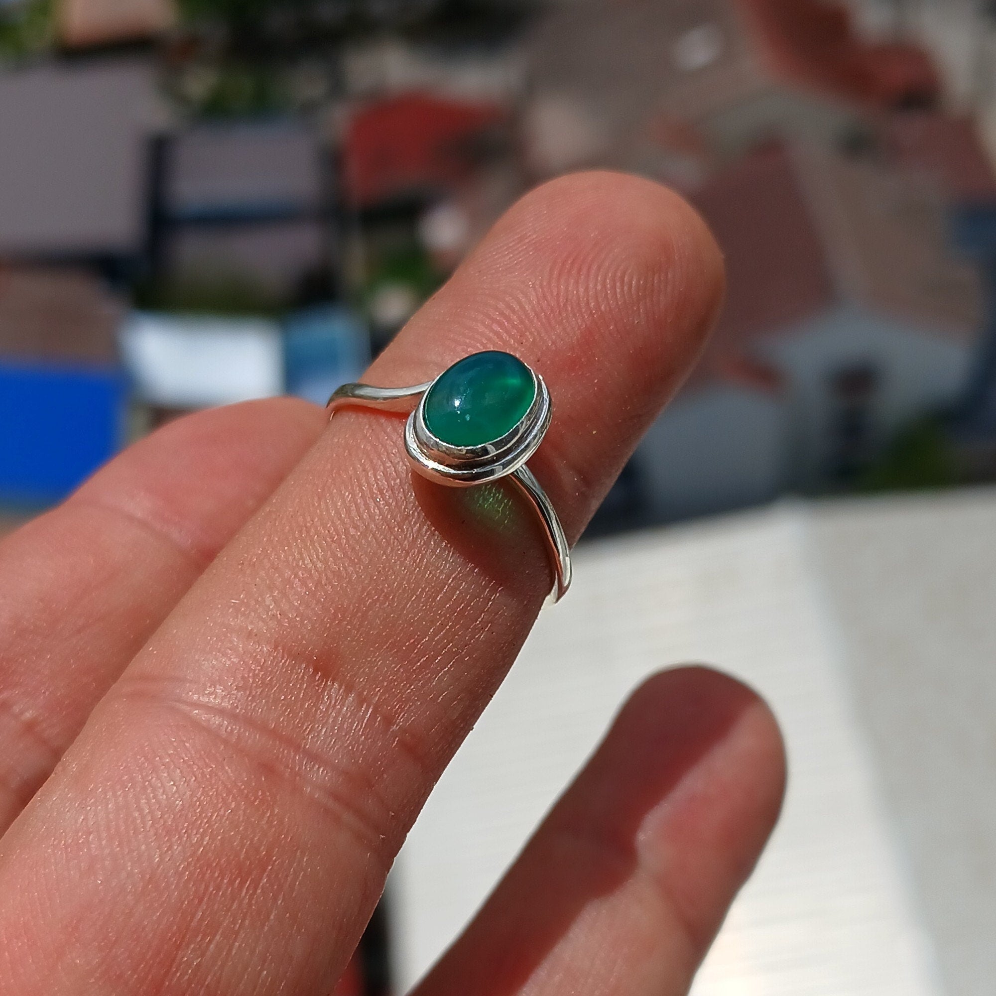 A minimalist Green Agate Ring featuring a handmade sterling silver band and an oval green Agate cabochon, elegantly polished.