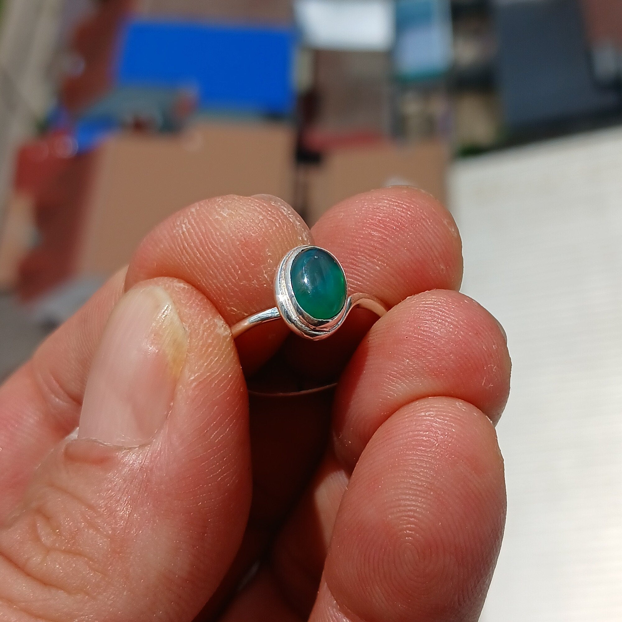 A minimalist Green Agate Ring featuring a handmade sterling silver band and an oval green Agate cabochon, elegantly polished.