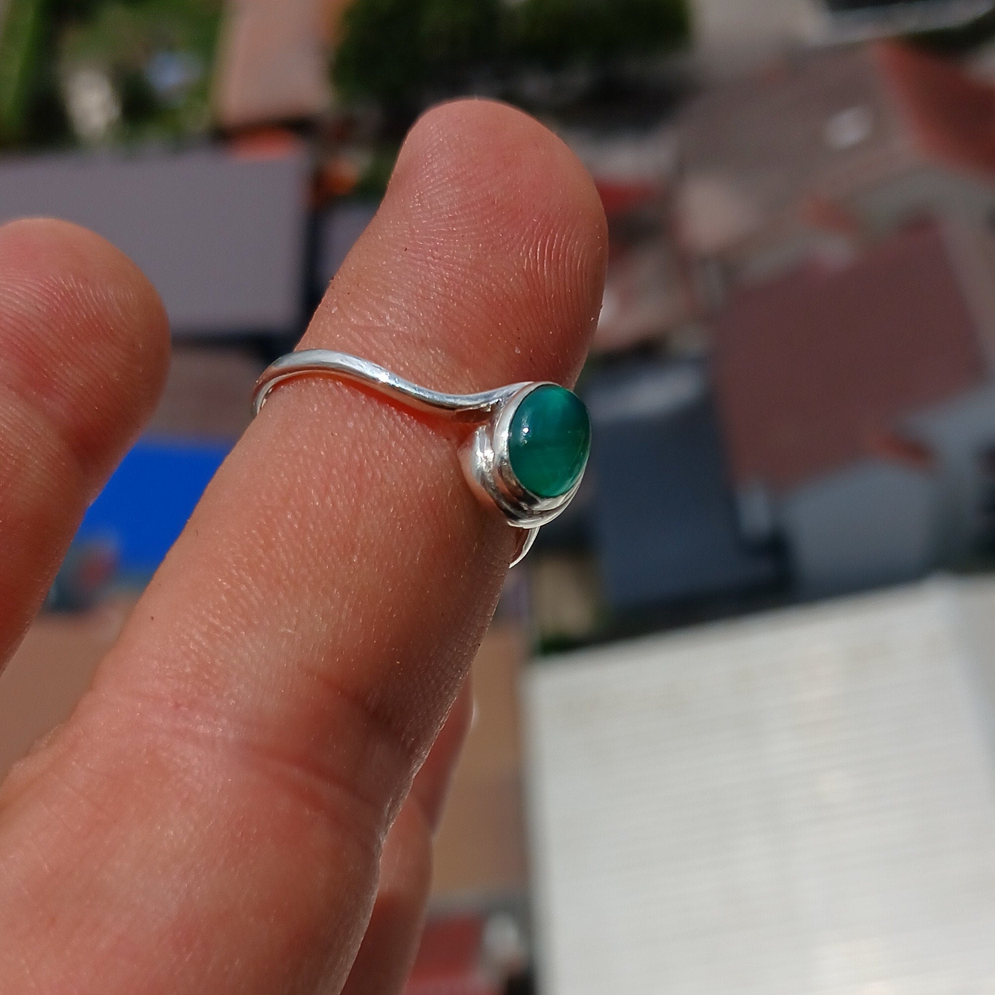 A minimalist Green Agate Ring featuring a handmade sterling silver band and an oval green Agate cabochon, elegantly polished.