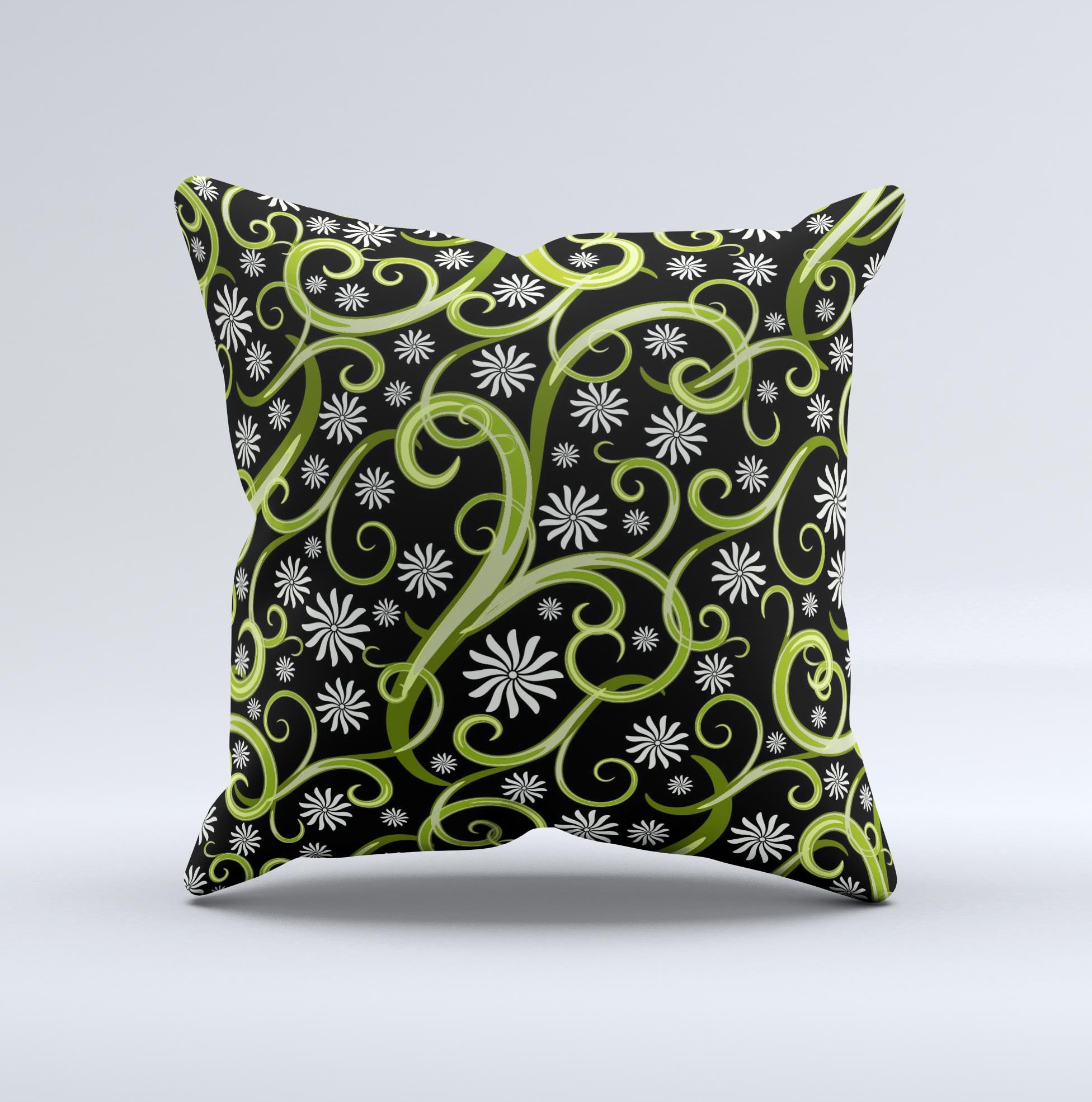 A decorative throw pillow featuring green floral swirls on a black background, showcasing a unique handcrafted design.