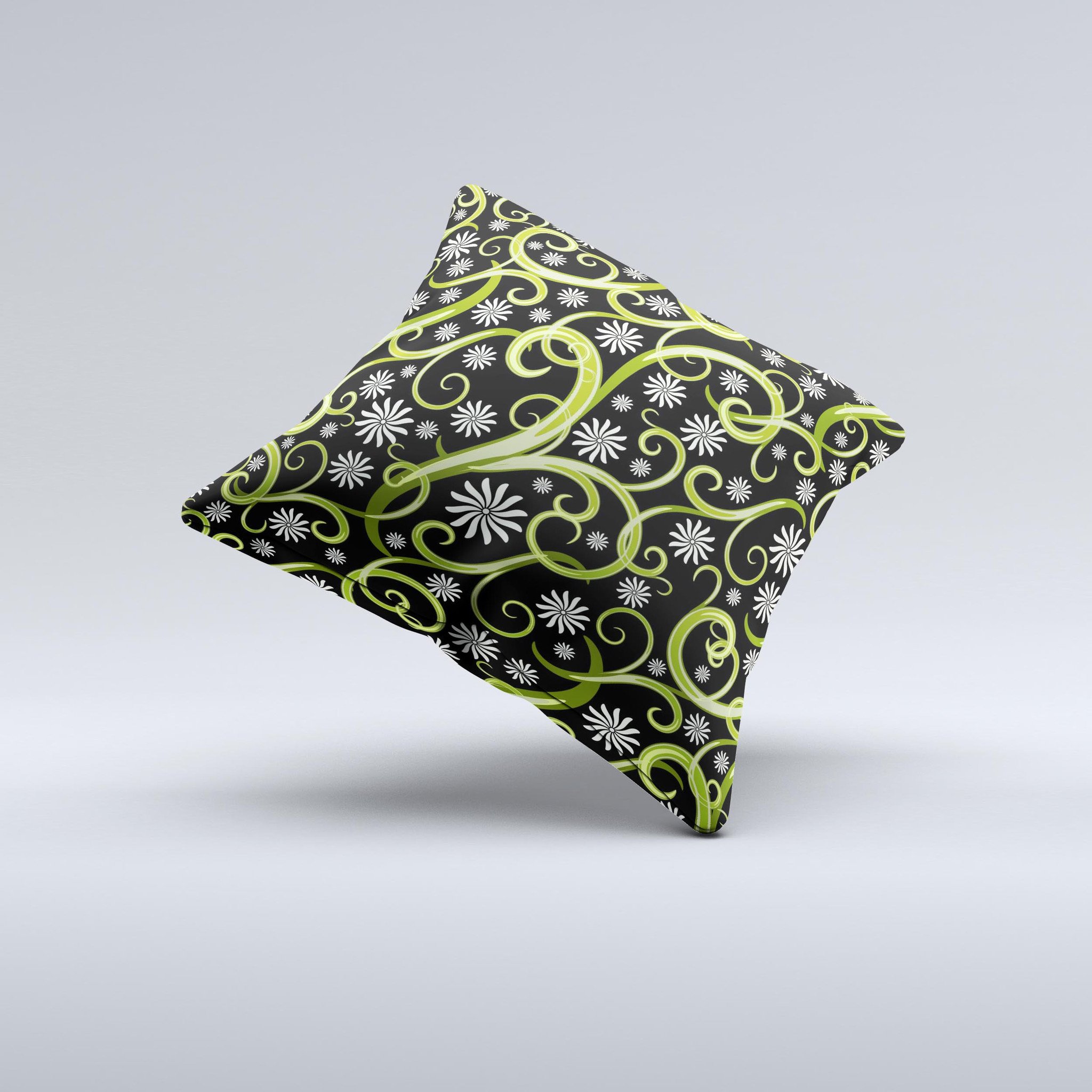 A decorative throw pillow featuring green floral swirls on a black background, showcasing a unique handcrafted design.