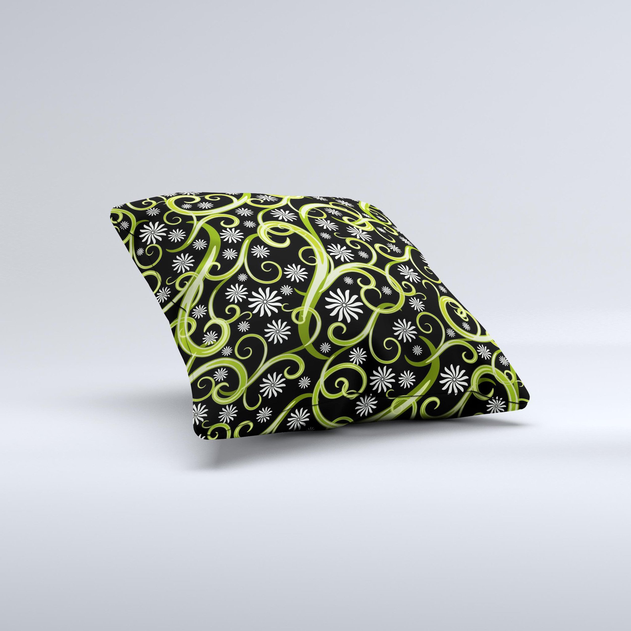 A decorative throw pillow featuring green floral swirls on a black background, showcasing a unique handcrafted design.