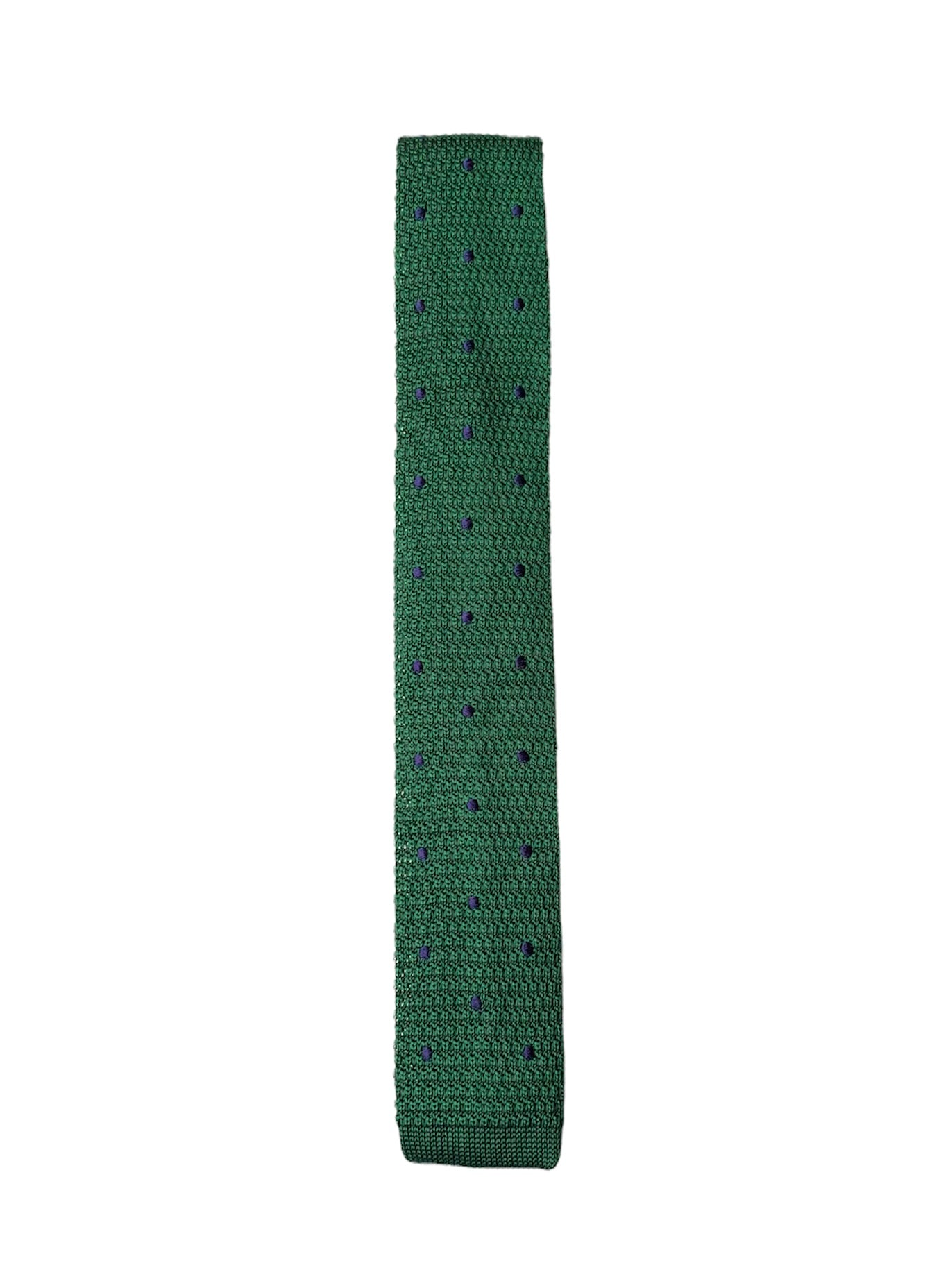 Green knitted tie with navy blue polka dots, showcasing a square end design.