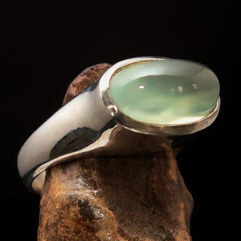 Handmade sterling silver solitaire ring featuring an oval green Prehnite stone, showcasing a polished finish and minimalist design.