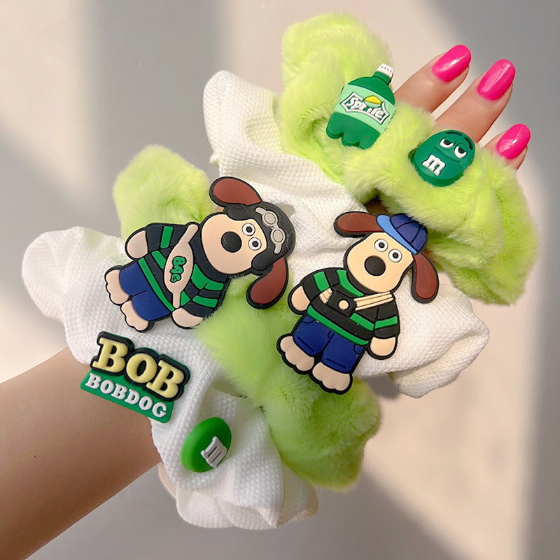 A vibrant green plush hair tie, soft and stylish, perfect for adding a playful touch to hairstyles.