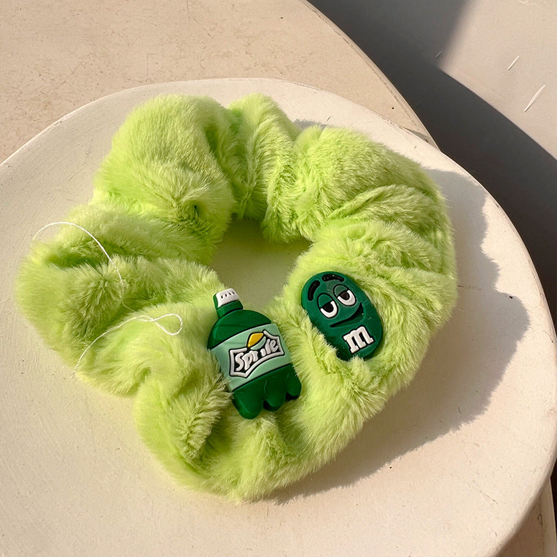 A vibrant green plush hair tie, soft and stylish, perfect for adding a playful touch to hairstyles.