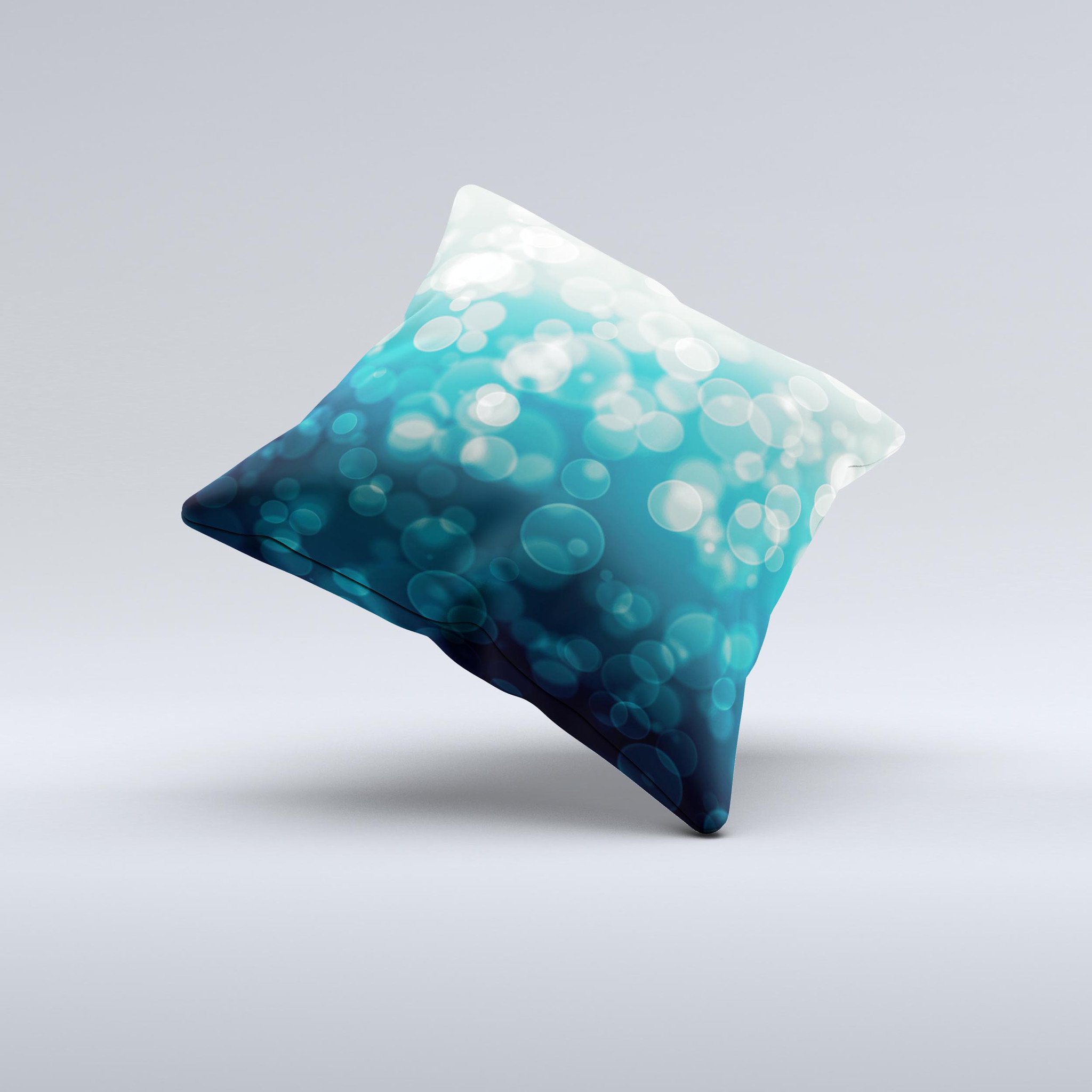 A decorative throw pillow featuring green unfocused orbs of light design, handcrafted in Virginia with a high thread count fabric and plush filling.