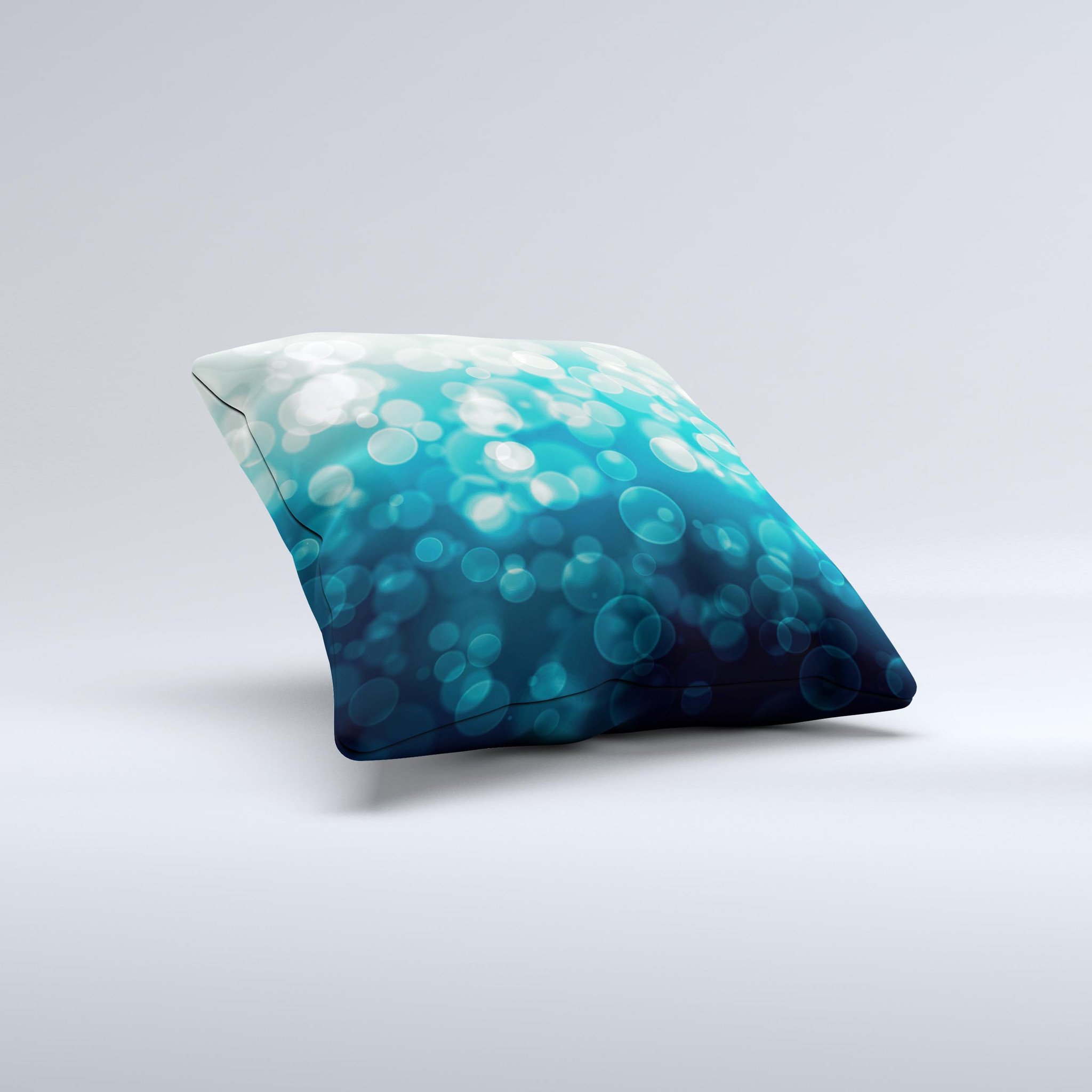 A decorative throw pillow featuring green unfocused orbs of light design, handcrafted in Virginia with a high thread count fabric and plush filling.