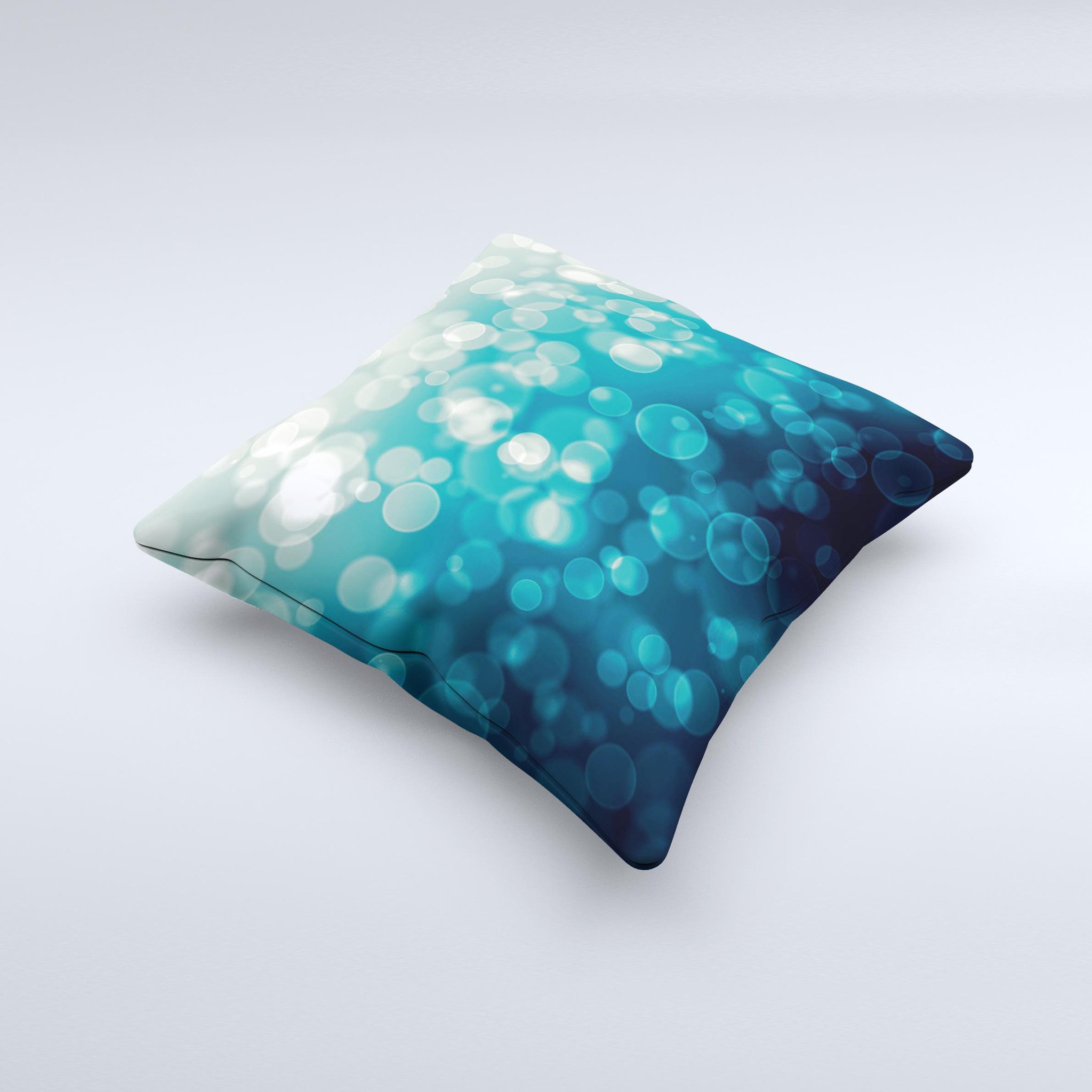 A decorative throw pillow featuring green unfocused orbs of light design, handcrafted in Virginia with a high thread count fabric and plush filling.