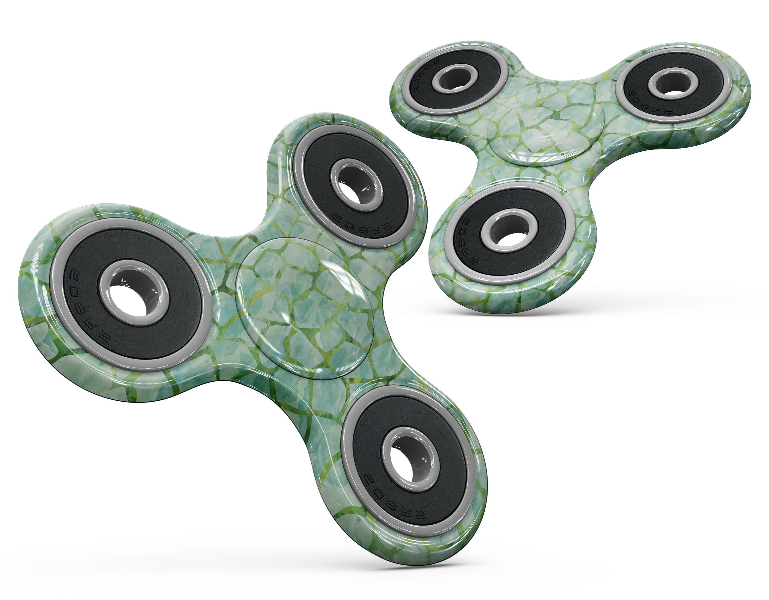 A fidget spinner adorned with a green watercolor giraffe pattern skin, showcasing vibrant colors and intricate design.