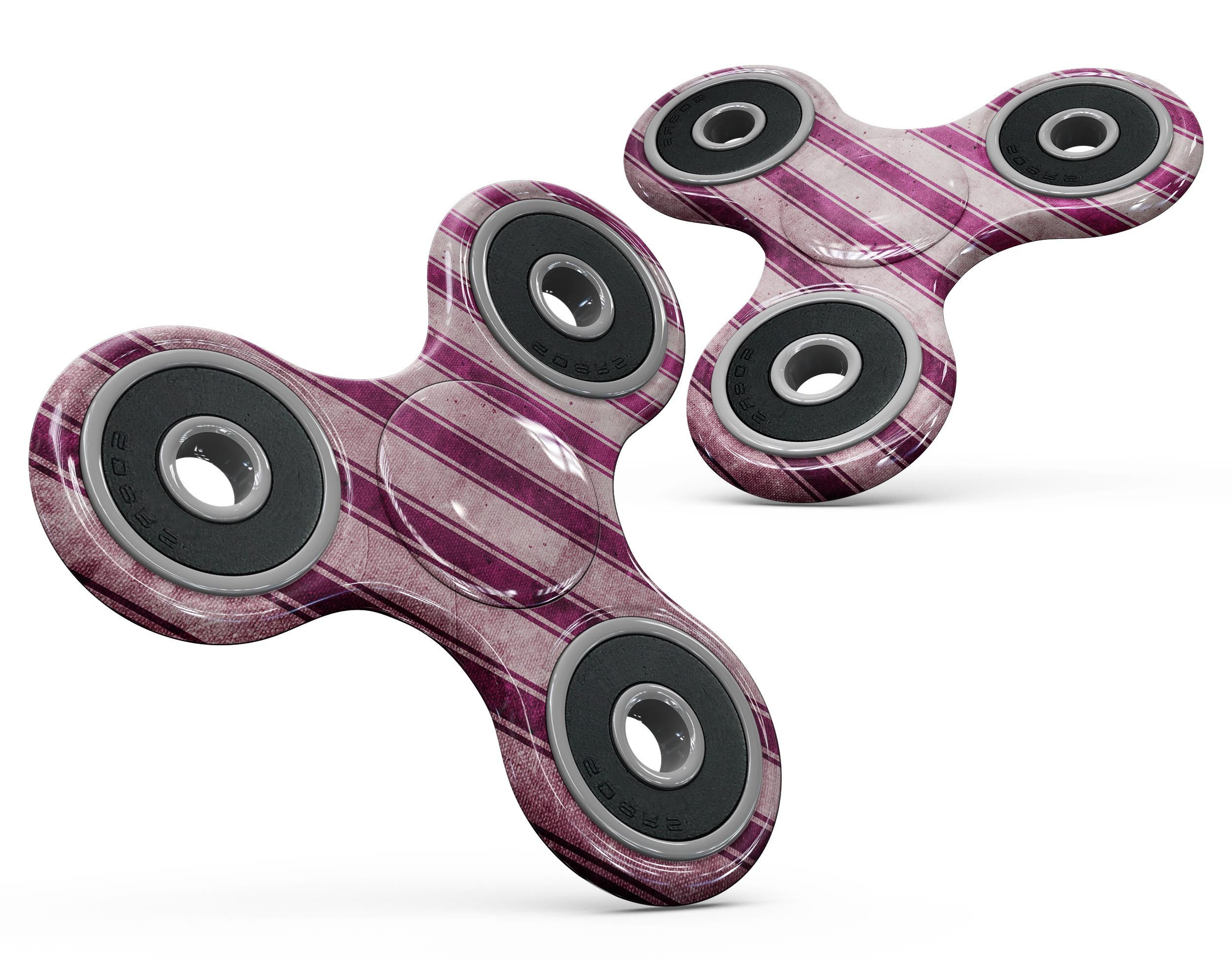 Grungy magenta and pink vertical stripes fidget spinner skin, showcasing vibrant colors and a stylish design.