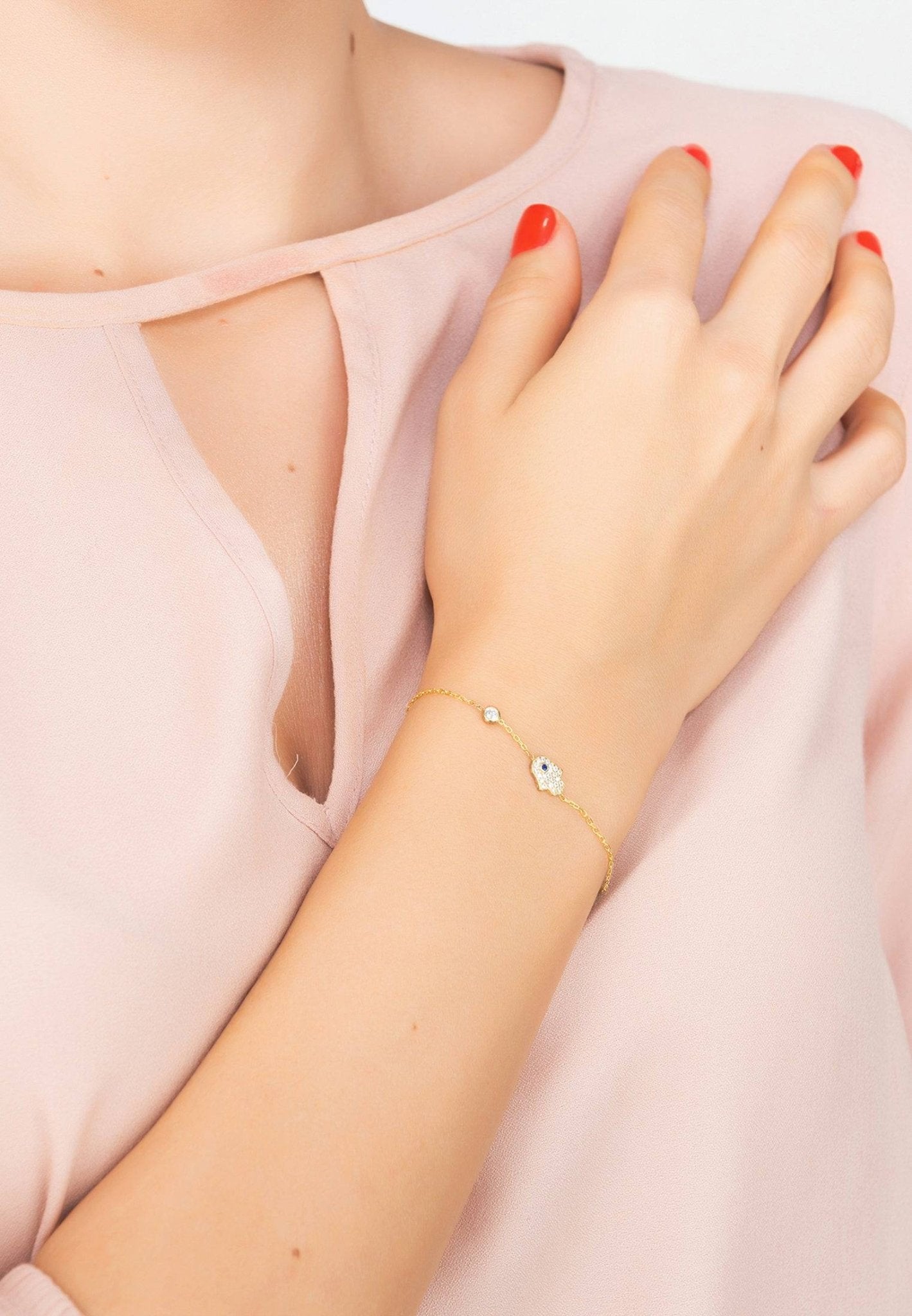 A stylish Hamsa Hand Bracelet made of 925 sterling silver, featuring white zircons and available in gold, rosegold, or rhodium finishes.