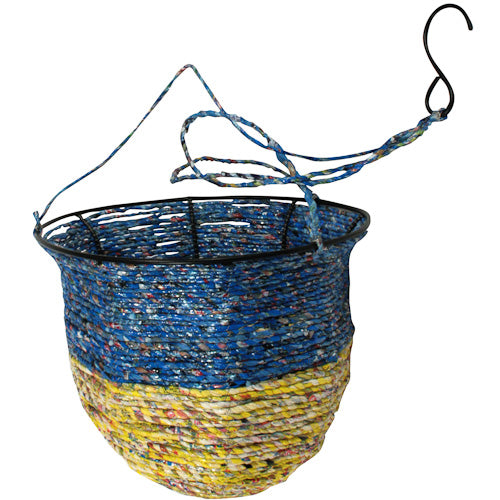 Colorful hanging basket made from recycled candy wrappers, showcasing intricate craftsmanship and eco-friendly design.