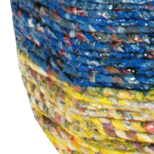 Colorful hanging basket made from recycled candy wrappers, showcasing intricate craftsmanship and eco-friendly design.