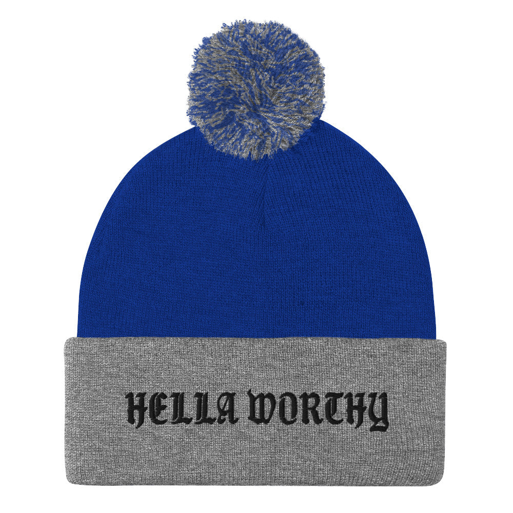 Hella Worthy Pom-Pom Beanie in a classic embroidered design with a playful pom-pom on top, showcasing its warm and stylish features.