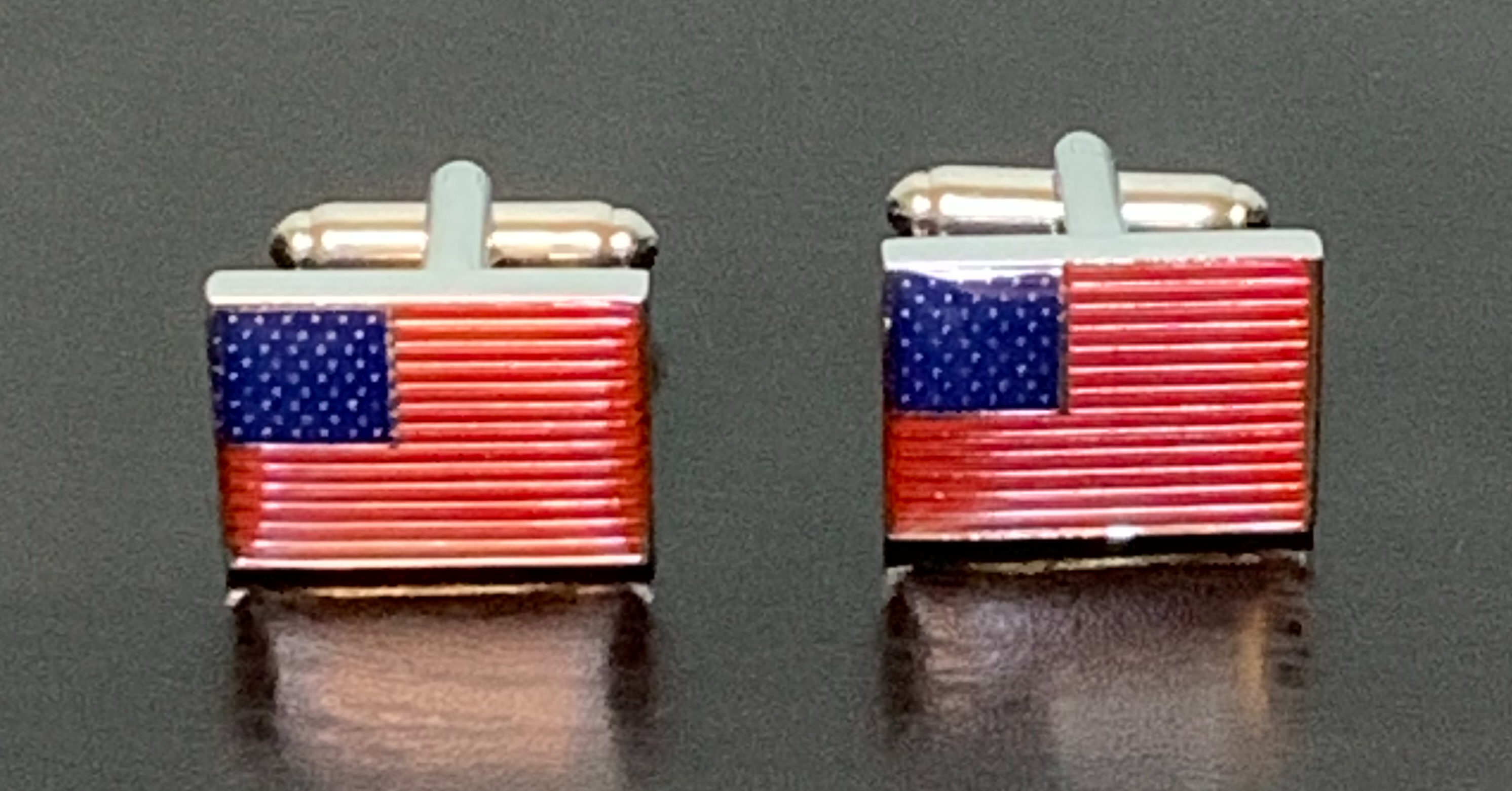 A pair of stylish cufflinks featuring the American flag design, showcasing the Stars and Stripes in vibrant colors.