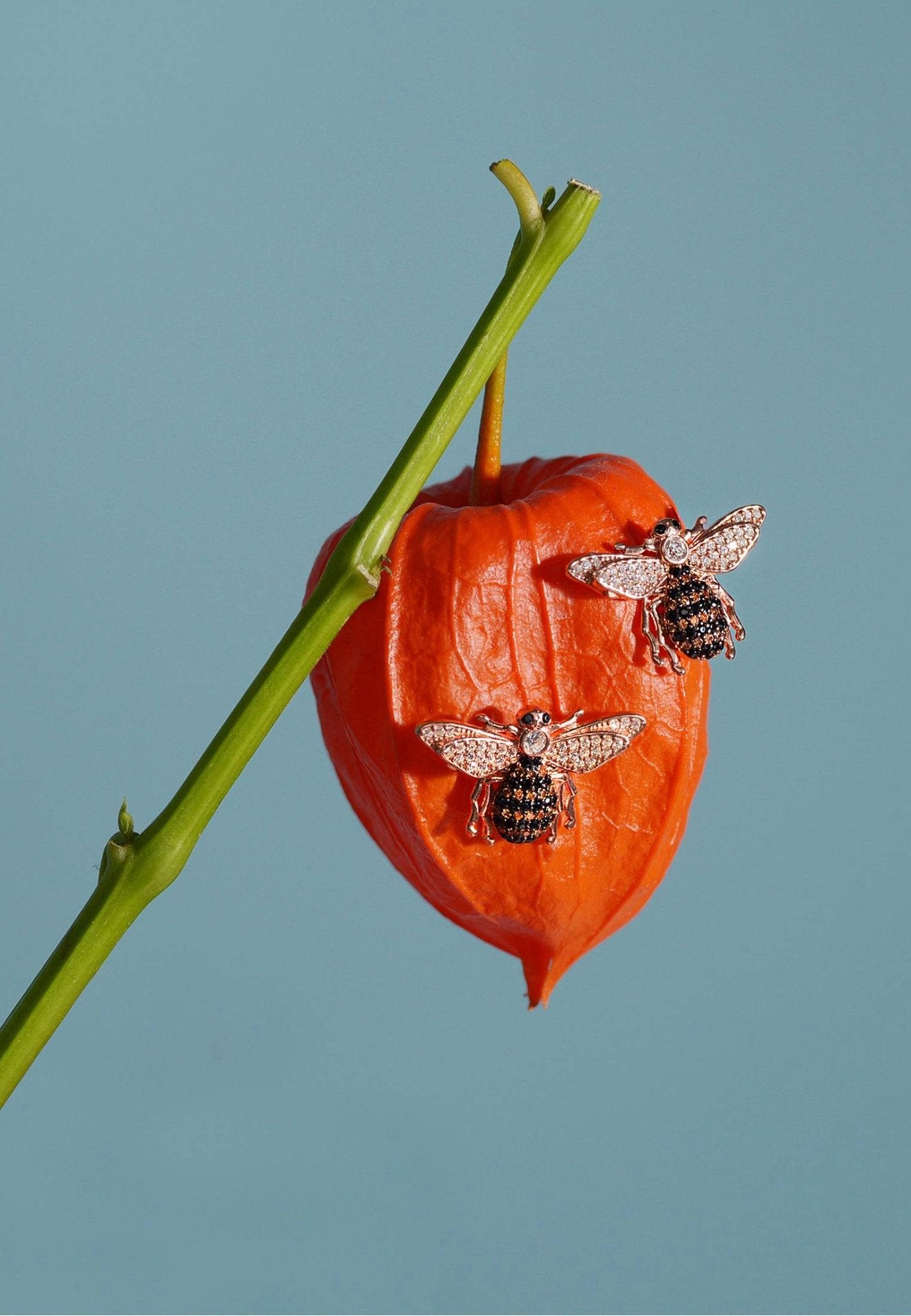 A pair of elegant Honey Bee Stud Earrings made from sterling silver, dipped in 22ct gold, featuring sparkling zircons and a cute bee charm.