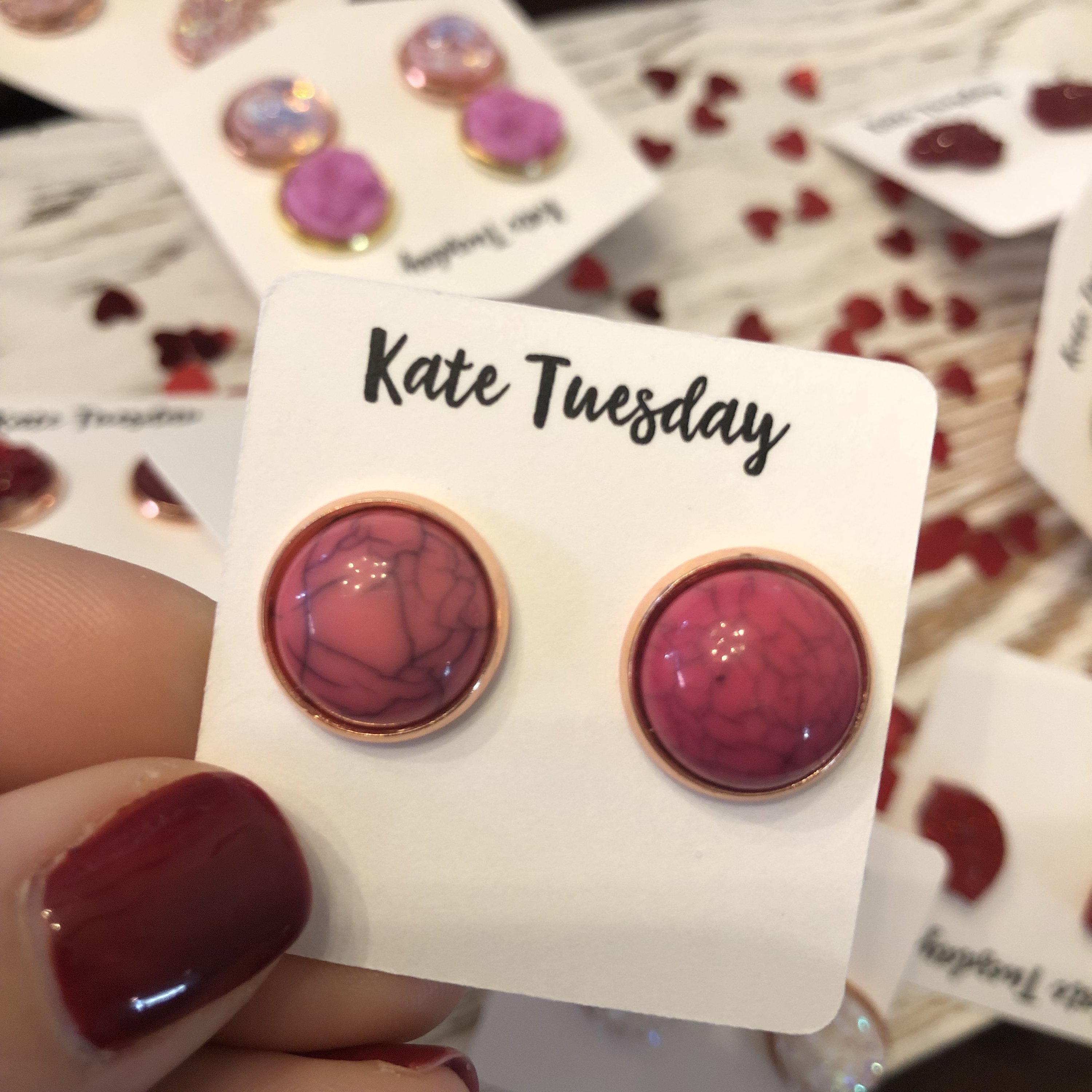 Pink stud earrings on display.