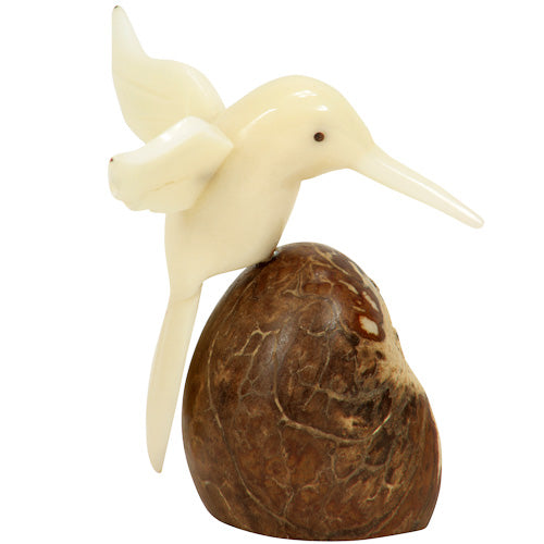 Handcrafted Humming Bird figurine made from tagua nut, showcasing natural wings and intricate details, symbolizing eco-friendly artistry.