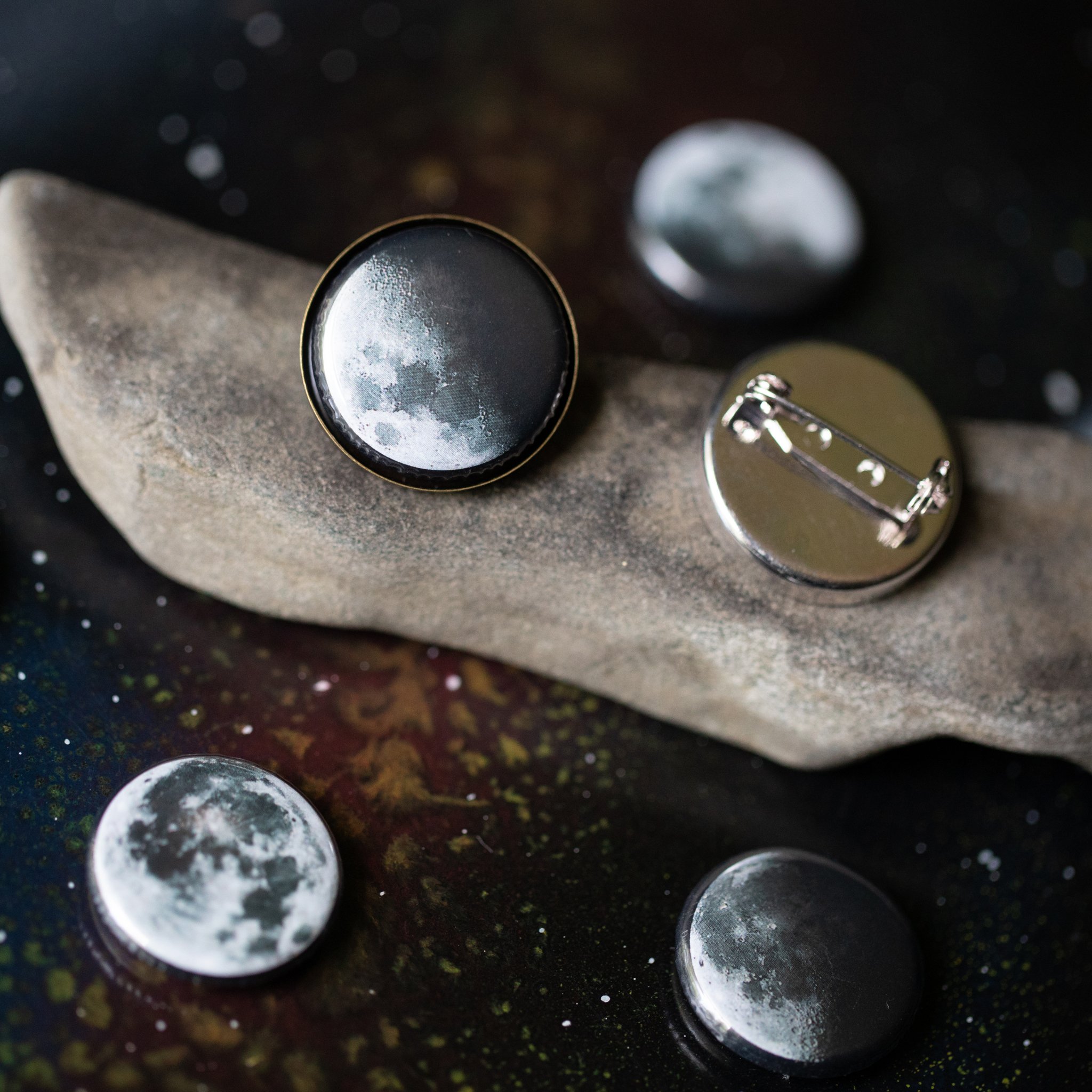 Interchangeable Moon Phase Lapel Pin set showcasing five lunar phases in silver and bronze tones, perfect for blazers and decorative displays.