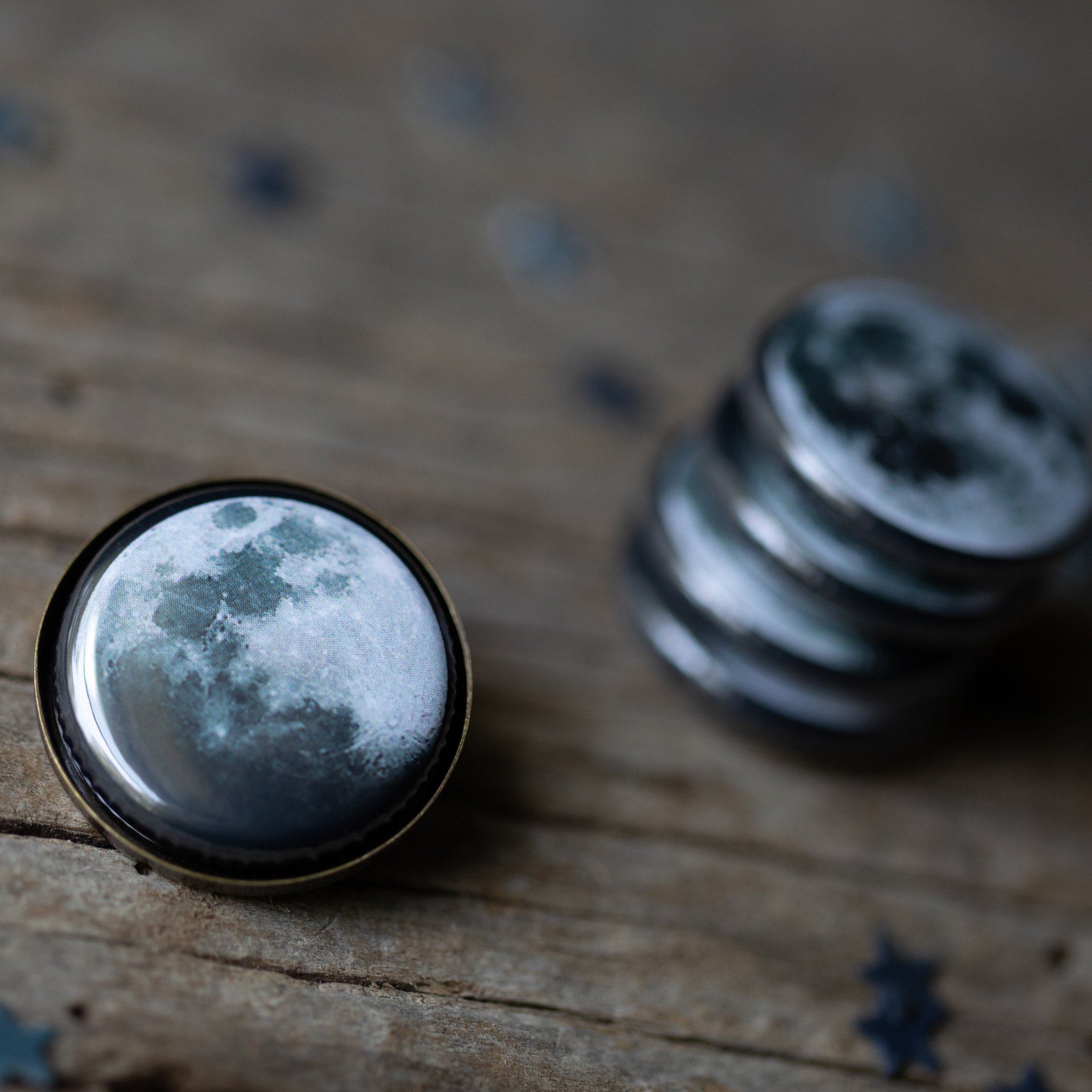 Interchangeable Moon Phase Lapel Pin set showcasing five lunar phases in silver and bronze tones, perfect for blazers and decorative displays.