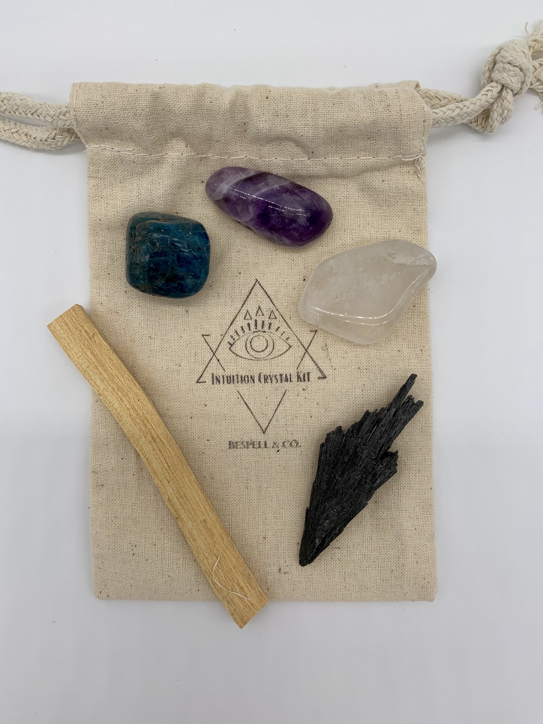 Intuition Crystal Set featuring Black Kyanite, Quartz, Amethyst, Apatite crystals, and a Palo Santo stick arranged aesthetically.