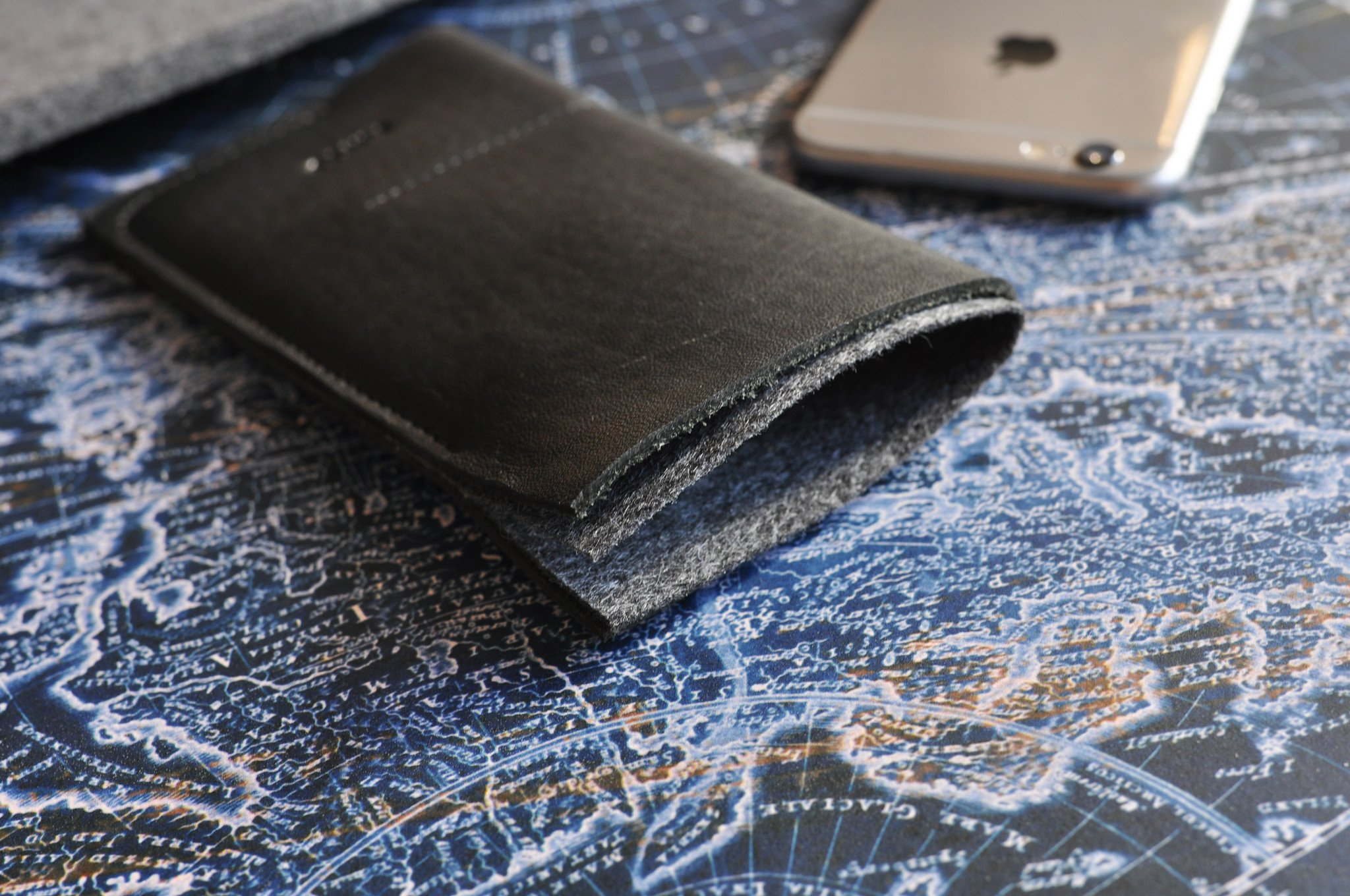 Stylish iPhone Wrap made from American Horween Leather and wool felt, featuring heat burnished details and slots for cash and cards.