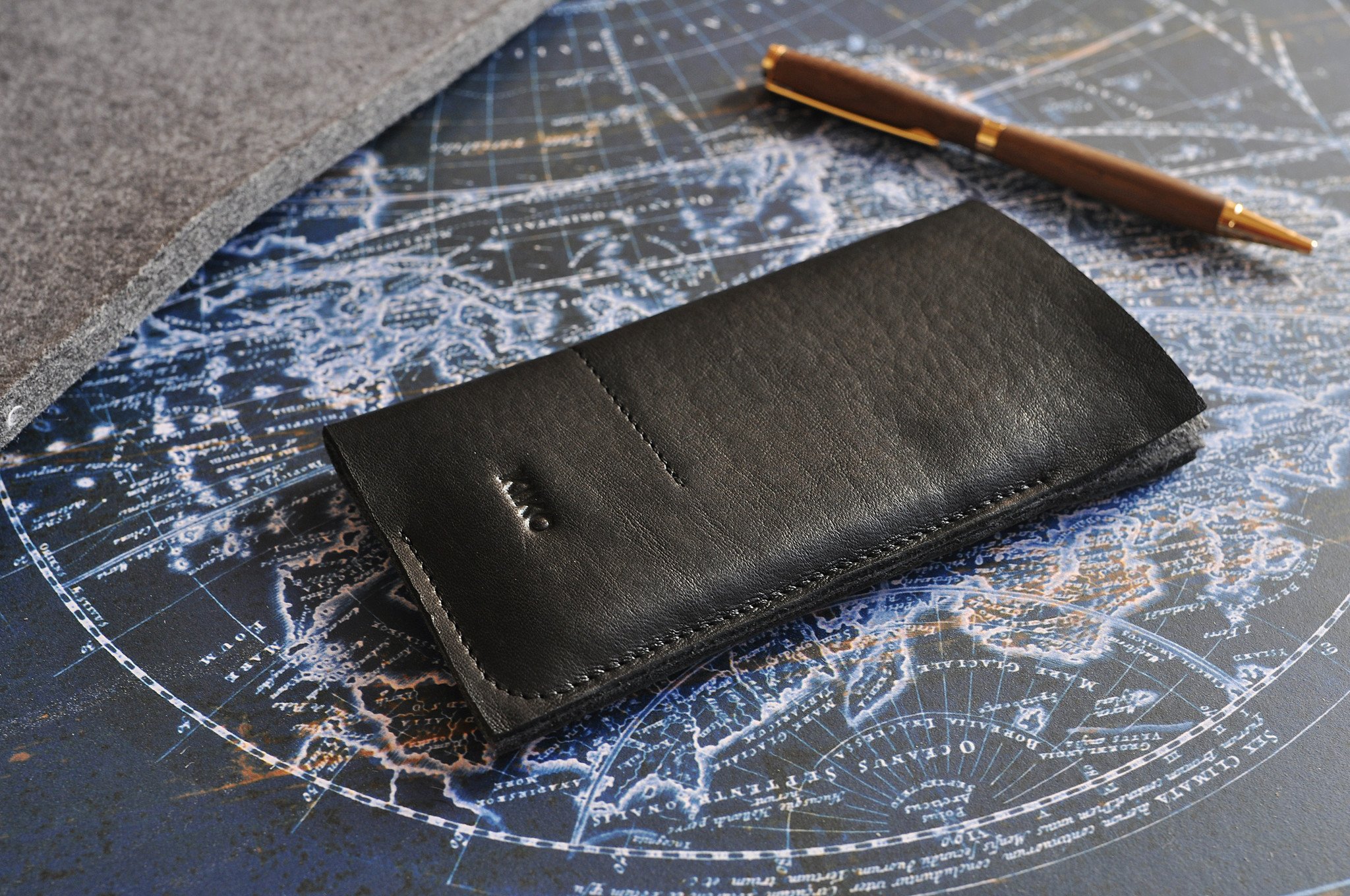 Stylish iPhone Wrap made from American Horween Leather and wool felt, featuring heat burnished details and slots for cash and cards.