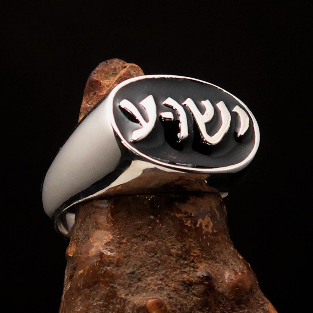 Sterling silver pinky ring featuring a black Hebrew word design spelling 'Jesus' on an oval face, showcasing its elegant finish.