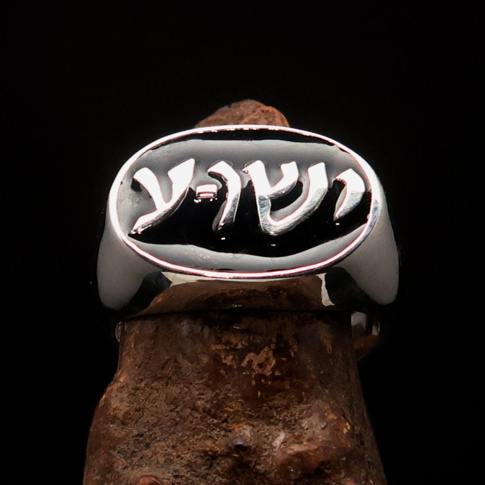 Sterling silver pinky ring featuring a black Hebrew word design spelling 'Jesus' on an oval face, showcasing its elegant finish.