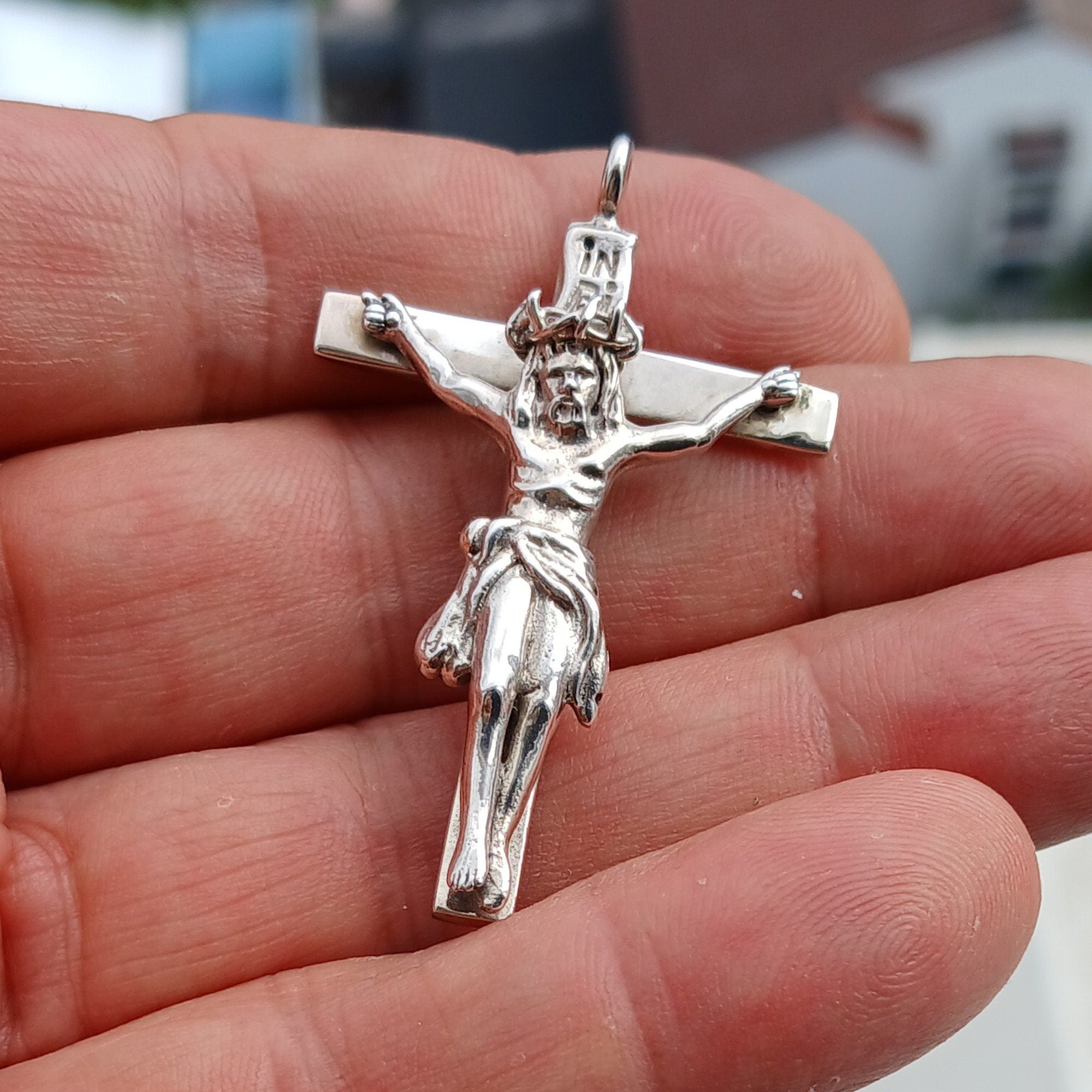 Sterling silver Jesus on the Cross pendant amulet, intricately designed with detailed craftsmanship.