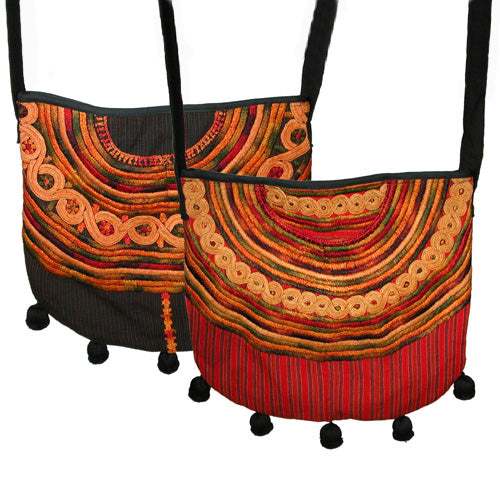 Joyabaj Shoulder Purse handmade from recycled huipils, featuring vibrant colors and ball fringe, perfect for everyday use.