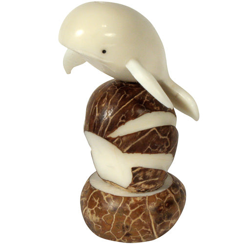 Hand-carved Jumping Whale figurine made from tagua nuts, showcasing intricate details and natural colors, symbolizing eco-friendly craftsmanship.