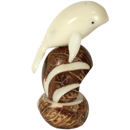 Hand-carved Jumping Whale figurine made from tagua nuts, showcasing intricate details and natural colors, symbolizing eco-friendly craftsmanship.