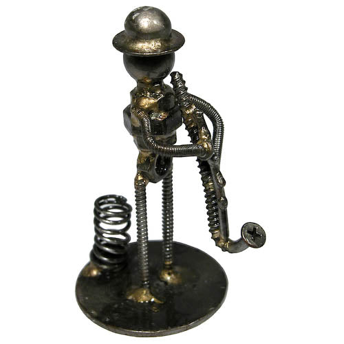 A whimsical pen holder shaped like a saxophone player, crafted from recycled metal scraps, showcasing creativity and artistry.