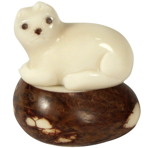 Hand-carved kitty cat figurine made from tagua nuts, showcasing natural colors and intricate details, symbolizing sustainable craftsmanship.